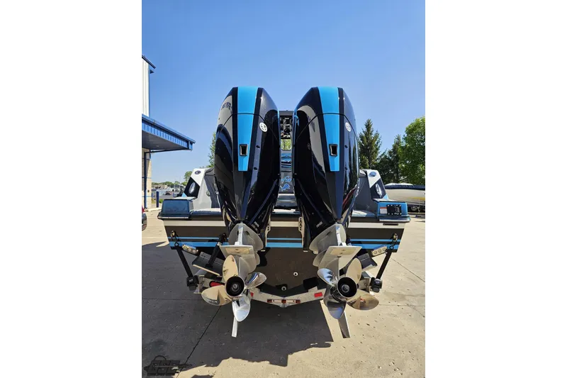 Slide: The Image of 2025 Sunsation 32 CCX boat with dual outboard engines, rear view in a sunny setting. - 36