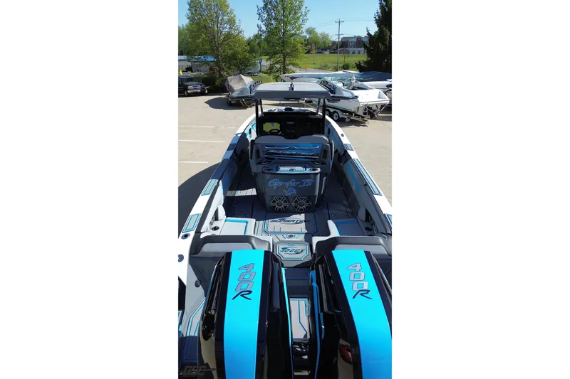 Slide: The Image of 2025 Sunsation 32 CCX boat with twin 400R engines, docked outdoors. - 43