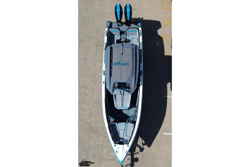 Slide: The Image of 2025 Sunsation 32 CCX boat, aerial view, sleek design, dual engines, docked on concrete surface. - 55