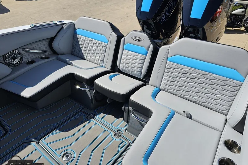 Slide: The Image of 2025 Sunsation 32 CCX boat interior with gray and blue seating, cup holders, and stylish flooring. - 59