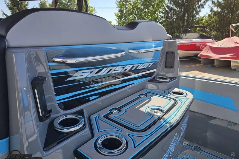 Slide: The Image of 2025 Sunsation 32 CCX boat interior with sleek design and cup holders. - 61