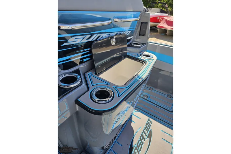 Slide: The Image of 2025 Sunsation 32 CCX boat interior with cup holders and storage compartment. - 62
