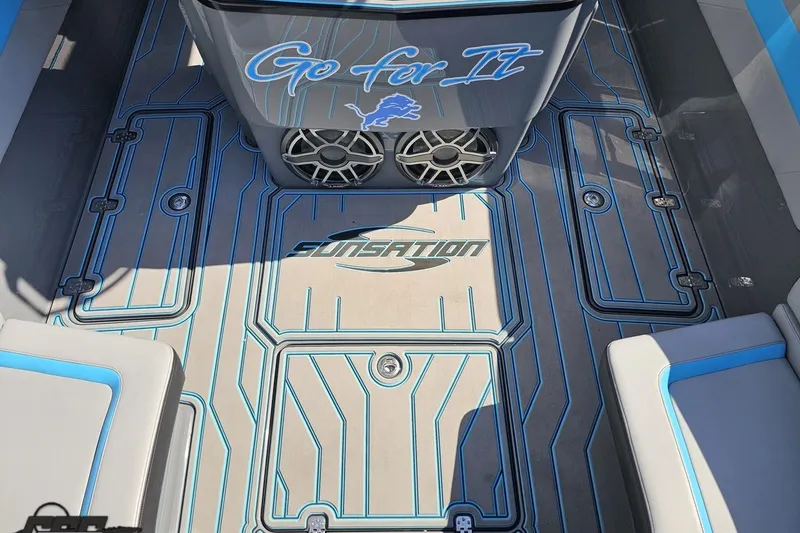 Slide: The Image of 2025 Sunsation 32 CCX boat interior with custom flooring and "Go for It" design. - 64