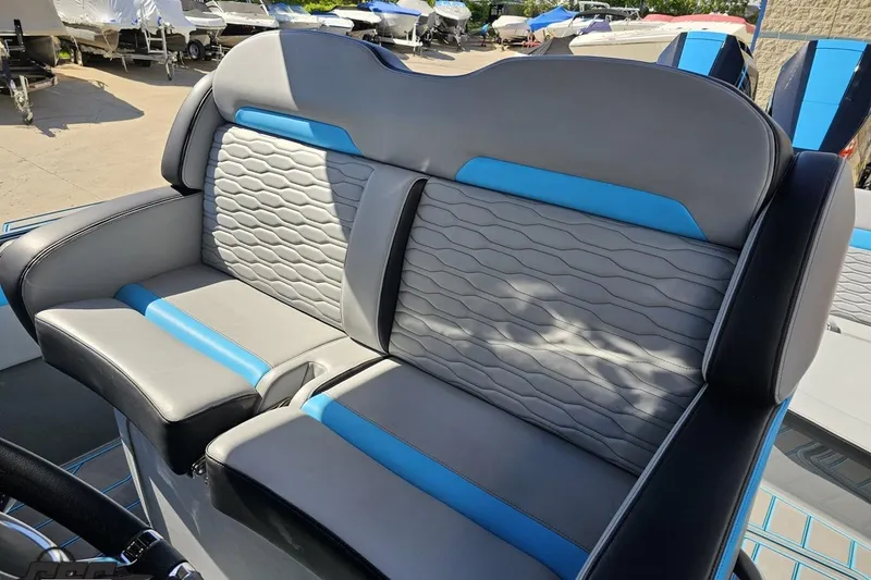 Slide: The Image of 2025 Sunsation 32 CCX boat seat with gray and blue upholstery, showcasing modern design. - 71