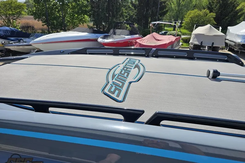 Slide: The Image of 2025 Sunsation 32 CCX boat deck with logo, surrounded by other boats in a marina. - 74