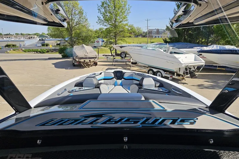 Slide: The Image of 2025 Sunsation 32 CCX boat interior view at marina, showcasing sleek design and seating. - 81