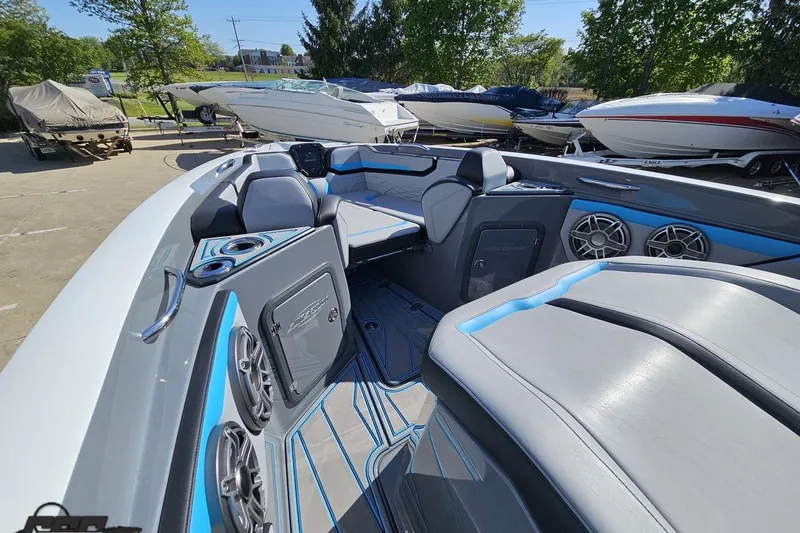 Slide: The Image of 2025 Sunsation 32 CCX boat interior with modern seating and audio system in a marina setting. - 91