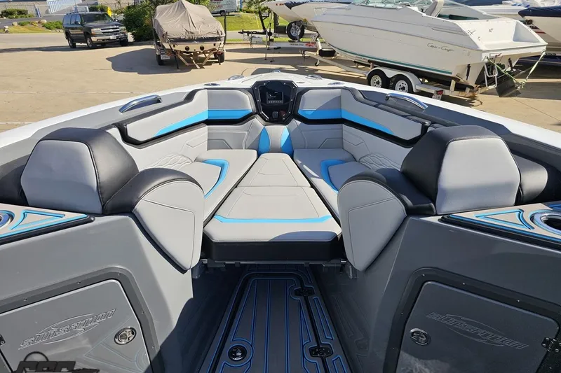 Slide: The Image of 2025 Sunsation 32 CCX boat interior with modern seating and blue accents. - 94