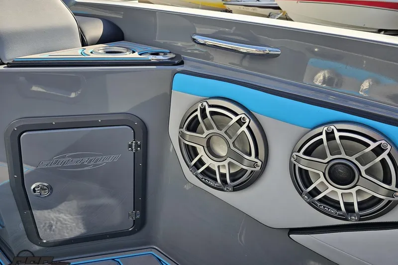 Slide: The Image of 2025 Sunsation 32 CCX boat interior with JL Audio speakers and storage compartment. - 95