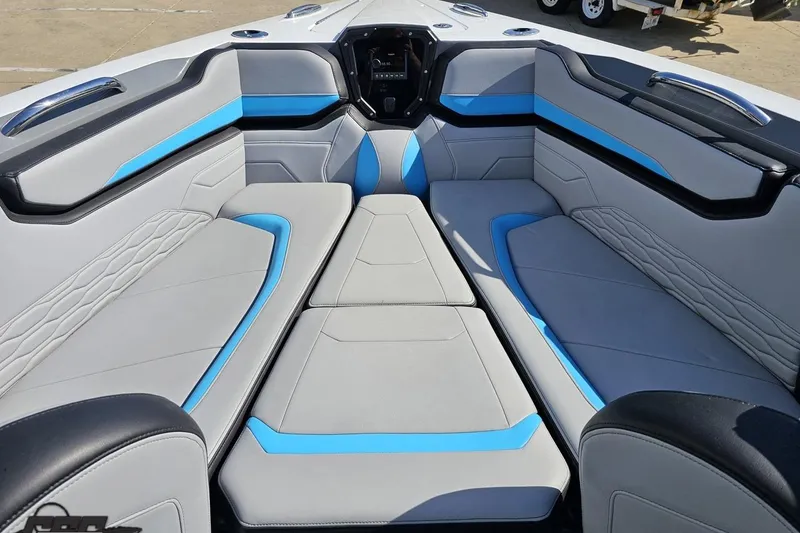 Slide: The Image of 2025 Sunsation 32 CCX boat interior with modern gray and blue seating design. - 97