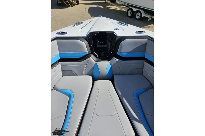 Slide: The Image of 2025 Sunsation 32 CCX boat interior with gray and blue seating, modern design. - 98