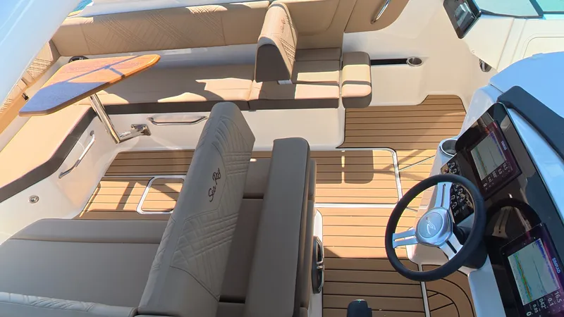Slide: The Image of Interior of a 2027 Sea Ray SDX 270 Outboard with sleek seating and a modern helm. - 7