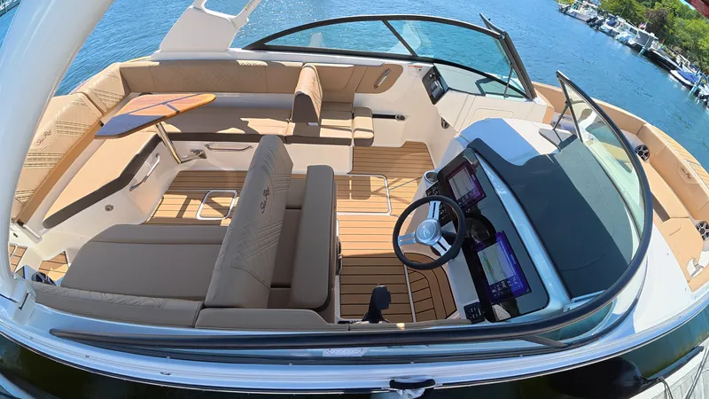 Slide: The Image of The image shows the cockpit of a 2027 Sea Ray SDX 270 Outboard with sleek seating and a modern helm. - 6