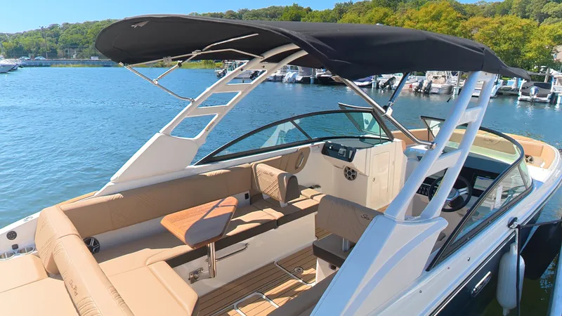 Slide: The Image of The image shows a 2027 Sea Ray SDX 270 Outboard boat with a black sunshade. - 11
