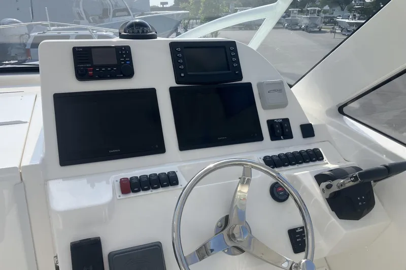 Slide: The Image of 2024 Albemarle 30 Express helm with modern navigation and control systems. - 12
