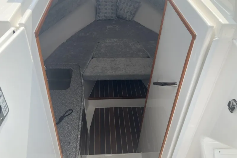 Slide: The Image of 2024 Albemarle 30 Express cabin interior with bed and kitchenette. - 13
