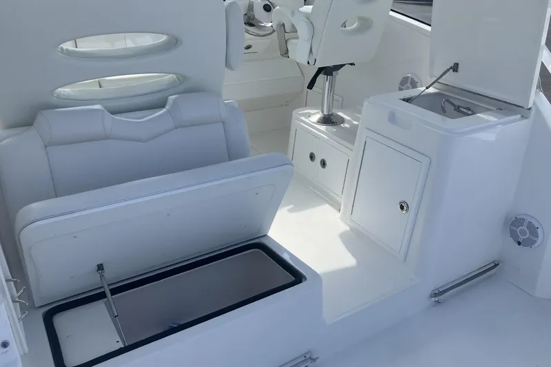 Slide: The Image of 2024 Albemarle 30 Express boat interior with seating, storage, and helm station. - 14