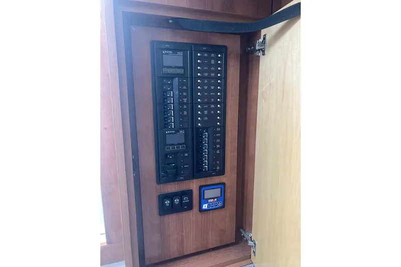 Slide: The Image of Electrical panel inside 2024 Albemarle 30 Express boat, featuring switches and controls. - 15
