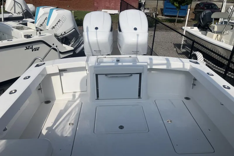 Slide: The Image of 2024 Albemarle 30 Express boat with dual outboard engines, spacious deck, and storage compartments. - 4