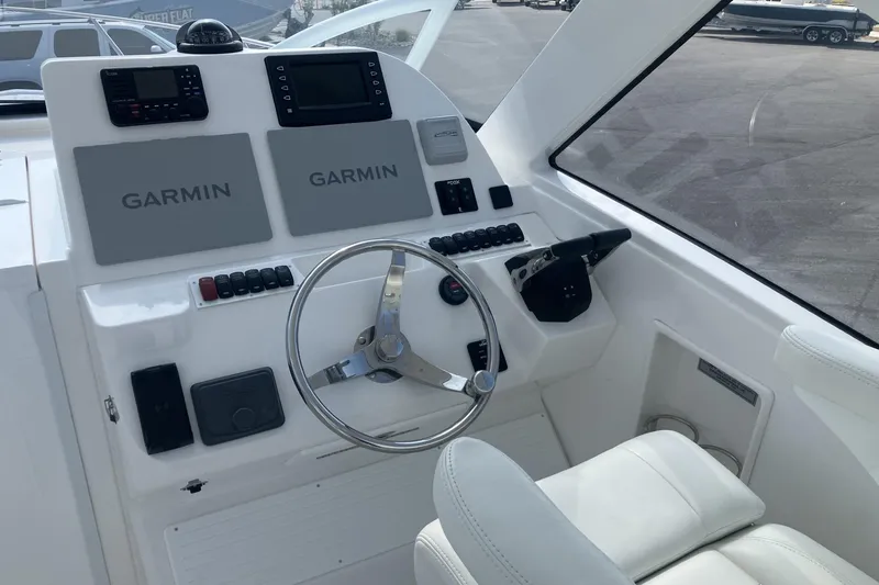 Slide: The Image of Helm of 2024 Albemarle 30 Express boat with Garmin navigation systems and steering wheel. - 5