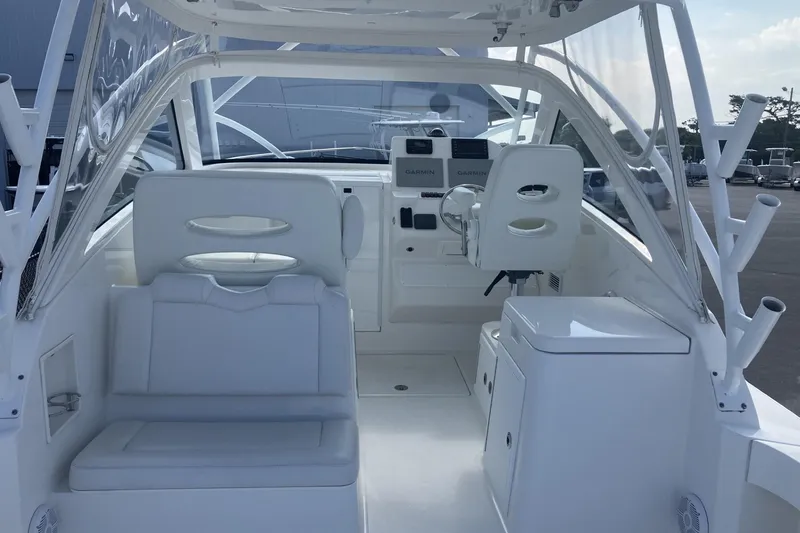 Slide: The Image of 2024 Albemarle 30 Express boat interior with white seating and navigation equipment. - 6