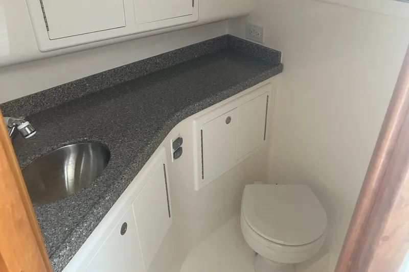 Slide: The Image of 2024 Albemarle 30 Express boat bathroom with sink, countertop, and toilet. - 9