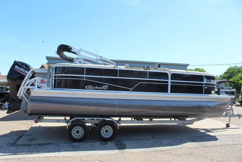 Slide: The Image of 2019 Misty Harbor 2285 Adventure Fishing pontoon boat on trailer, side view. - 3