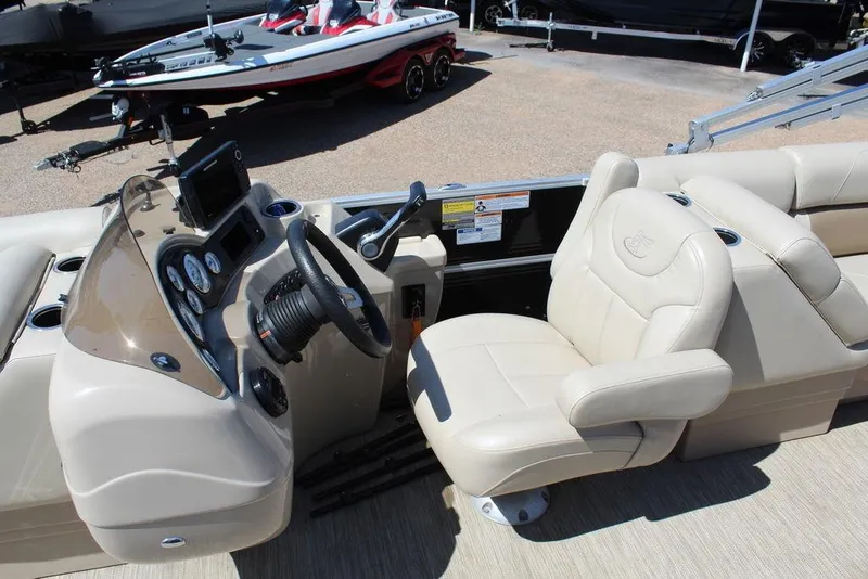 Slide: The Image of 2019 Misty Harbor 2285 Adventure Fishing boat interior with steering console and beige seating. - 4