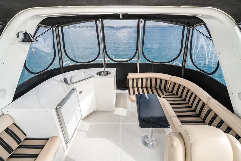 Slide: The Image of Luxurious interior of 2006 Navigator 5100 yacht with striped seating and ocean view. - 12