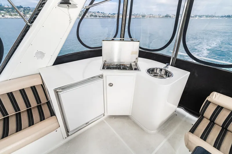 Slide: The Image of Interior of 2006 Navigator 5100 yacht with kitchenette and seating, overlooking water. - 13
