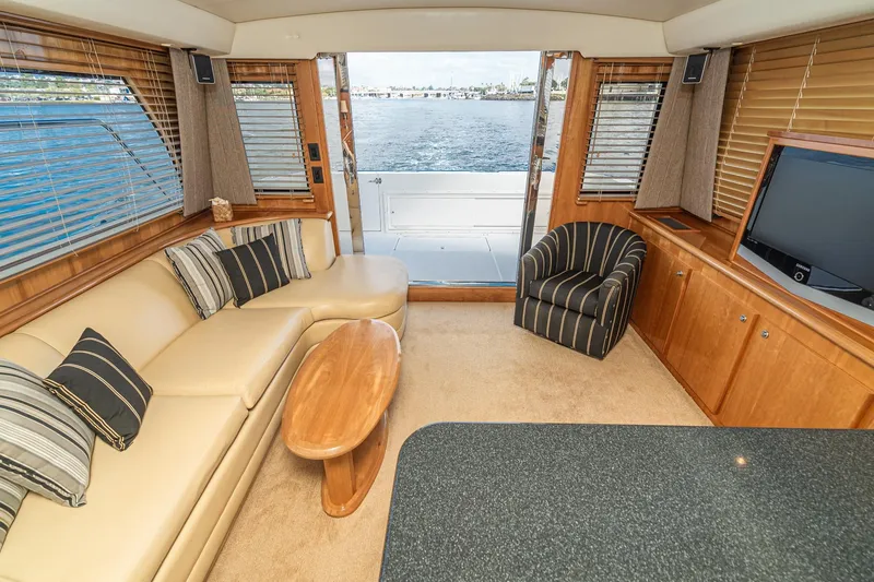 Slide: The Image of Luxurious 2006 Navigator 5100 yacht interior with elegant seating, wood accents, and ocean view. - 16