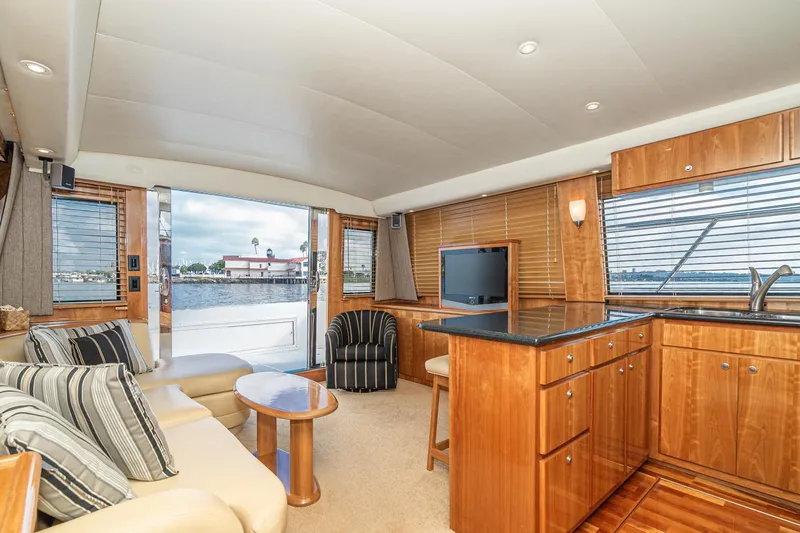 Slide: The Image of Luxurious interior of 2006 Navigator 5100 yacht with elegant wood finishes and waterfront view. - 17