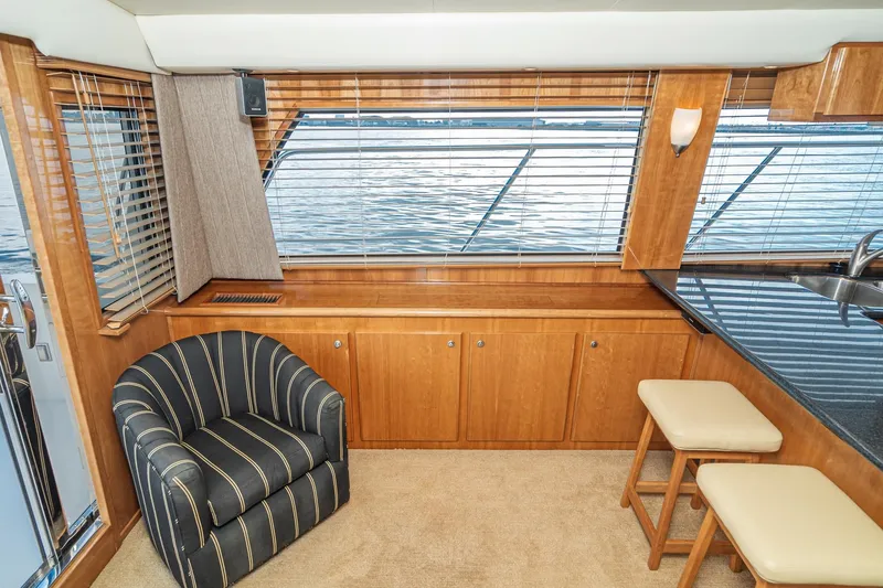 Slide: The Image of Luxurious interior of 2006 Navigator 5100 yacht with striped chair and wooden cabinetry. - 19