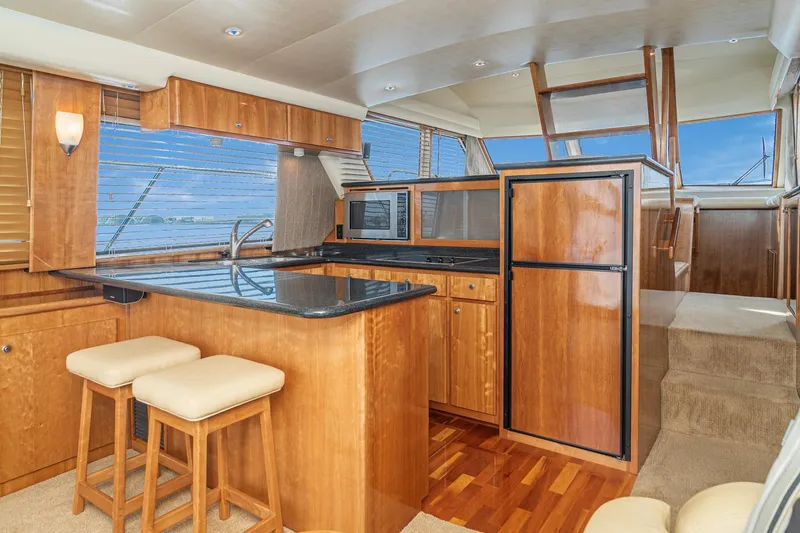 Slide: The Image of Luxurious 2006 Navigator 5100 yacht interior with modern kitchen and wooden cabinetry. - 23