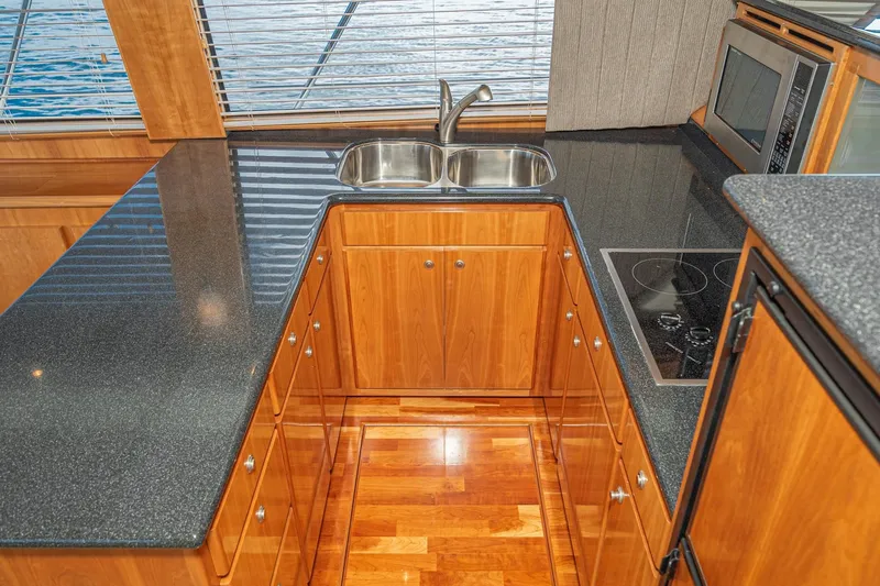 Slide: The Image of Luxurious 2006 Navigator 5100 yacht kitchen with sleek countertops and modern appliances. - 26