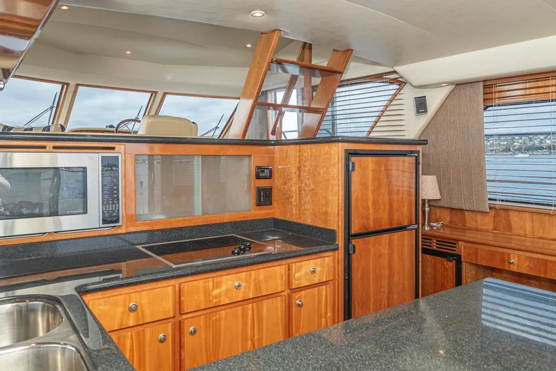 Slide: The Image of Luxurious 2006 Navigator 5100 yacht kitchen with wood cabinetry and modern appliances. - 27
