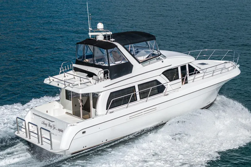 Slide: The Image of 2006 Navigator 5100 yacht cruising on open water, showcasing sleek design and luxury features. - 3