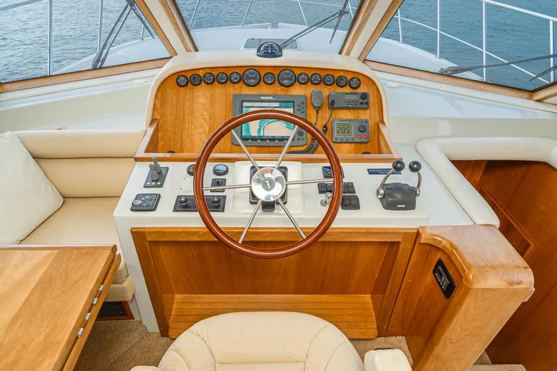 Slide: The Image of Helm of 2006 Navigator 5100 yacht with wooden dashboard and modern navigation controls. - 31
