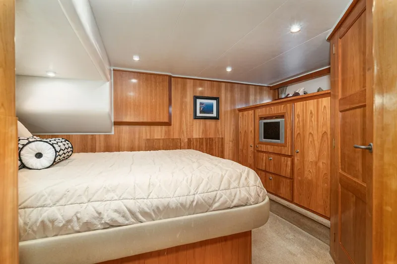 Slide: The Image of Luxurious 2006 Navigator 5100 yacht bedroom with wood paneling and cozy bedding. - 35