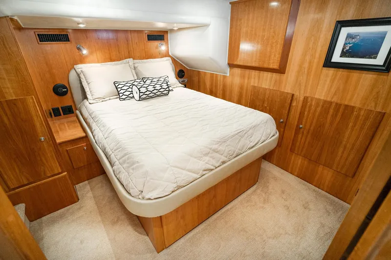 Slide: The Image of Luxurious 2006 Navigator 5100 yacht bedroom with wood paneling and cozy bedding. - 36