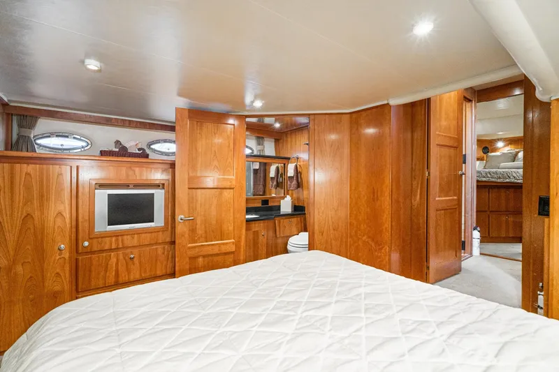 Slide: The Image of Luxurious 2006 Navigator 5100 yacht interior with wood paneling and cozy bedroom. - 38