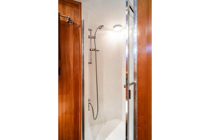 Slide: The Image of Shower area in 2006 Navigator 5100 yacht with wooden accents and modern fixtures. - 40