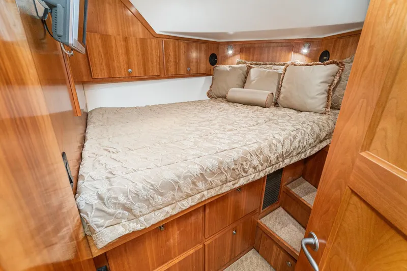 Slide: The Image of Luxurious cabin interior of 2006 Navigator 5100 yacht with elegant bedding and wood finish. - 42