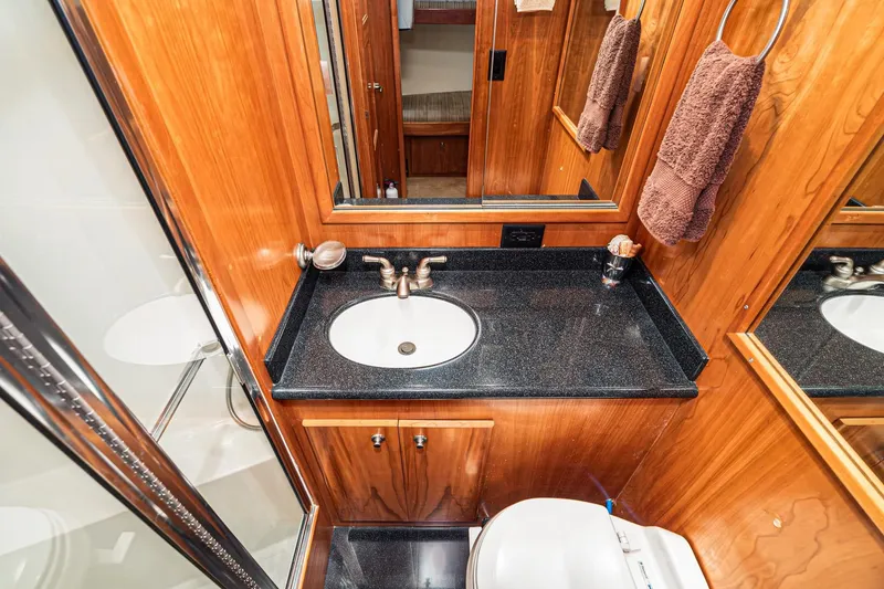Slide: The Image of Luxurious 2006 Navigator 5100 yacht bathroom with wood paneling and sleek black countertop. - 43