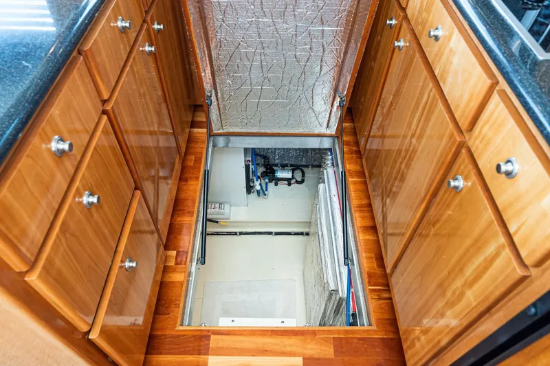 Slide: The Image of Engine room access in 2006 Navigator 5100 yacht, surrounded by wooden cabinetry. - 44