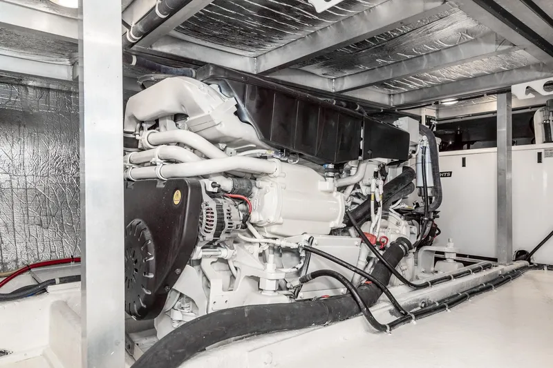Slide: The Image of Engine room of a 2006 Navigator 5100 yacht, showcasing mechanical components and piping. - 46