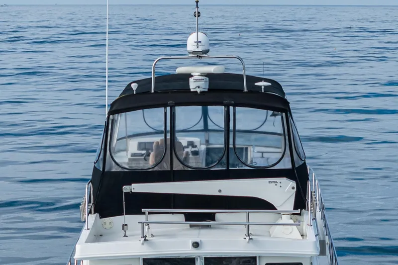 Slide: The Image of 2006 Navigator 5100 yacht on calm ocean waters, rear view. - 5