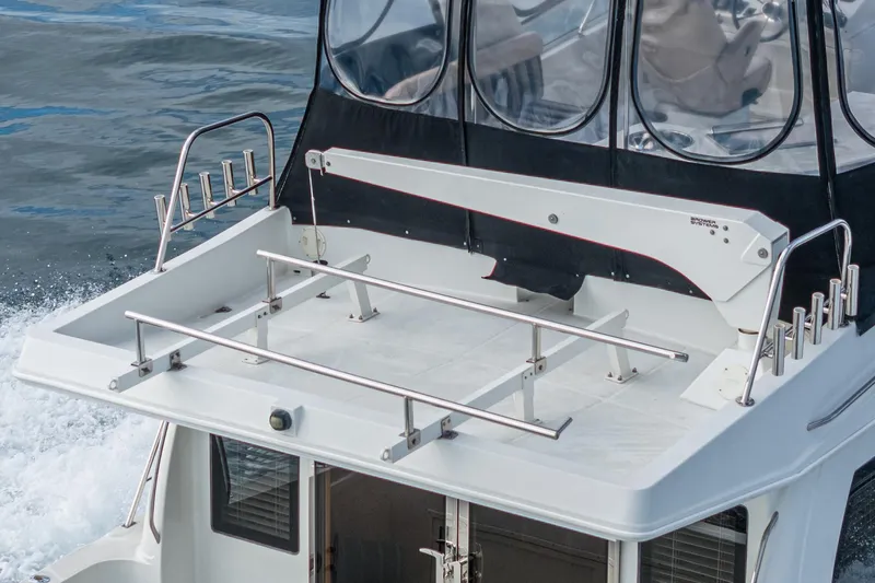 Slide: The Image of 2006 Navigator 5100 yacht deck with stainless steel railings and rod holders. - 6