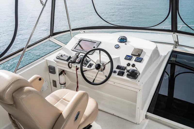 Slide: The Image of Helm of 2006 Navigator 5100 yacht with steering wheel and navigation controls. - 9