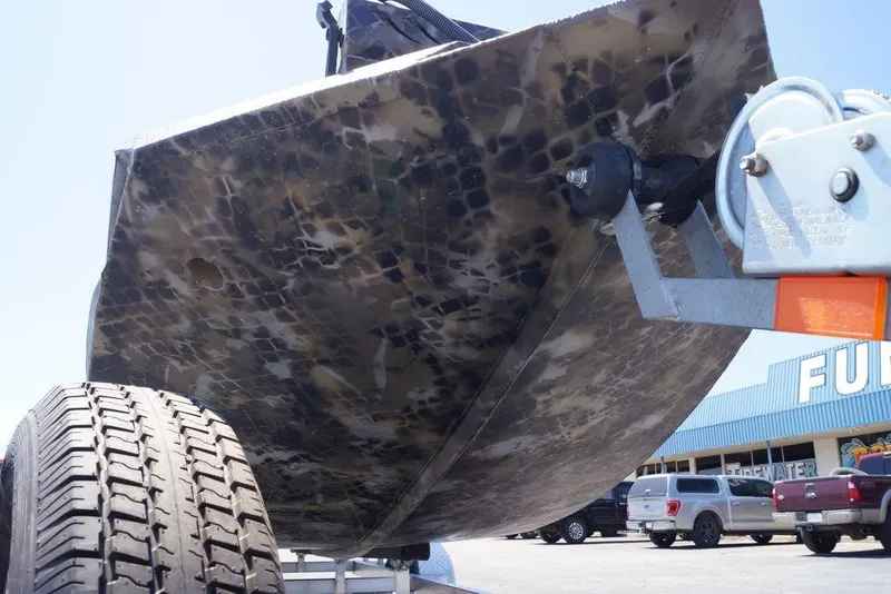 Slide: The Image of Bottom view of 2021 Excel 1751 F4 boat on trailer, showcasing camouflage pattern. - 12